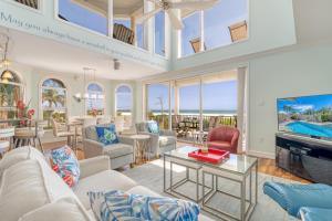 a living room with a lot of furniture and a tv at Admirals Watch - 673 in Siesta Key