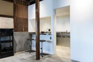 a kitchen with a counter and stools in a room at yutorie 貸切宿 2名から6名定員 熱海 来宮 in Atami