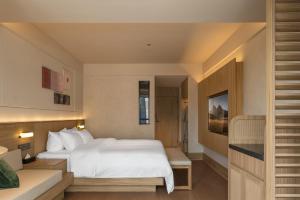 Rúm í herbergi á Maiyue Hotel-Xi`an Zhonggulou