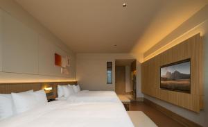 Rúm í herbergi á Maiyue Hotel-Xi`an Zhonggulou