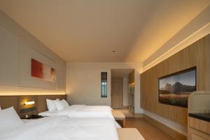 Rúm í herbergi á Maiyue Hotel-Xi`an Zhonggulou