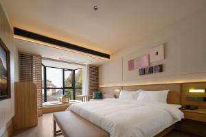 Rúm í herbergi á Maiyue Hotel-Xi`an Zhonggulou