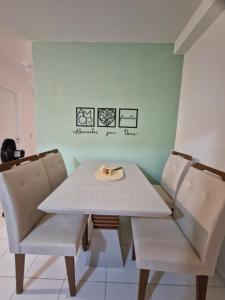 a white dining table and two chairs in a room at Apto Araçagy Ilha de São Luis in São-José-do-Ribamar +13 photos