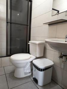 a bathroom with a toilet and a sink at Hostal María - Otavalo in Otavalo +10 photos