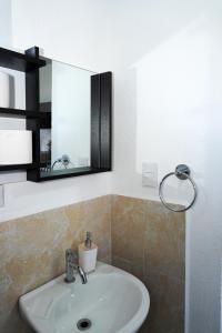 a bathroom with a sink and a mirror at La Petite Santa Ana in Santa Ana +22 photos