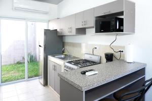a kitchen with a stove and a counter top at La Petite Santa Ana in Santa Ana
