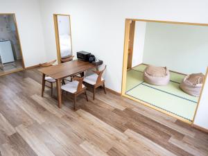 a room with a table and chairs and a mirror at section-inn in Chitose +25 photos