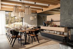 a dining room with a table and chairs at Villa La Roca Garden & Spa ADULTS ONLY in Kościelisko