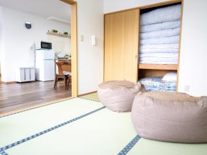 a room with a bean bag chair and a bedroom at section-inn in Chitose