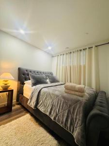 a bedroom with a large bed and a window at Comfy Neutral Living Free Parking in Calgary