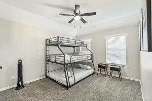 a bedroom with a bunk bed with a ceiling fan at Cozy 5BR Estate Lewisville - Office, Game Room in Lewisville