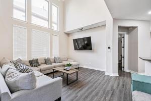 a living room with a couch and a tv at Cozy 5BR Estate Lewisville - Office, Game Room in Lewisville