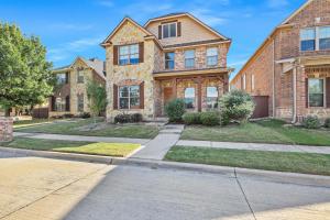 a large brick house with a driveway at Cozy 5BR Estate Lewisville - Office, Game Room in Lewisville
