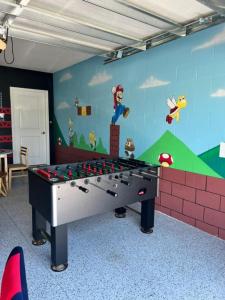 a ping pong table in a room with a wall at Luxury 2bd 2 bath Condo Home 232 in Davenport