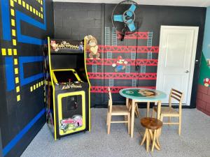 a room with a game system and a table and chairs at Luxury 2bd 2 bath Condo Home 232 in Davenport