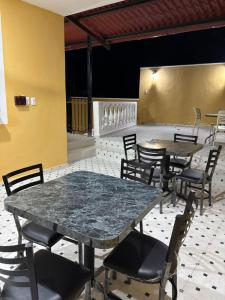 a dining room with tables and chairs in a room at Hotel Rodríguez in Izamal