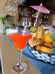 a drink in a glass next to a basket of fruit at Balai Ko Beach & Cottages in El Nido +31 photos