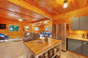a kitchen and living room in a log cabin at Charming 3BR with Hot Tub Balcony & Wood Stove in Guerneville