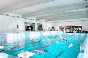 a group of people swimming in a swimming pool at Vinni Sport & Spa hostel in Vinni