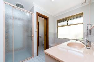 a bathroom with a sink and a glass shower at Moore than a Shack in Guilderton +19 photos