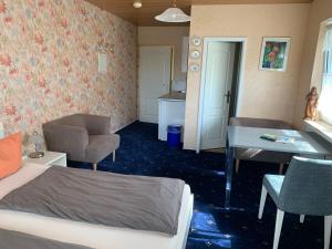 a bedroom with a bed and a desk and a table at Gästehaus am Lindenweg in Meersburg +82 photos