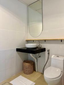 a bathroom with a sink and a toilet at 2BD beachfront house in Chaloclum in Mae Haad +52 photos