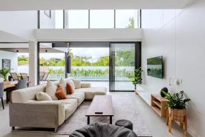 a living room with a couch and a table at Poon Pool villa near Ruamchok Boxing private pool etc in Chiang Mai