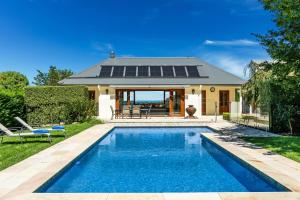 a swimming pool in the backyard of a house at Home in Exeter in Exeter
