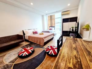 a room with a bed and a couch and a table at First Subang Courtyard SS15 Subang Jaya SJMC Taylors Nu Empire Subang Parade Sunway Pyramid Lagoon Medical Centre LRT KTM in Subang Jaya +34 photos