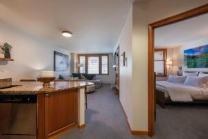 a kitchen and a bedroom with a bed in a room at Premium Unit 2308 - 1Br - Zephyr Mountain Lodge condo in Winter Park