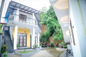 a view of a house from between two buildings at Kings Villa Mirissa in Mirissa
