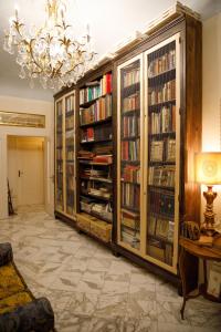 a large library with book shelves filled with books at Florence Dream Domus in Florence