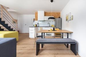 a kitchen and dining room with a table in a room at Holiday Home by Lake Wise ka with Sauna in Wisełka
