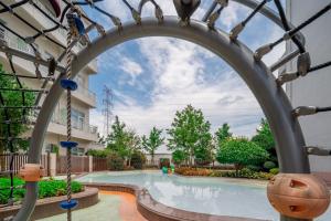 a large swimming pool with an arch in a building at NARADA Resort Shanghai Hotel Disney Store in Shanghai