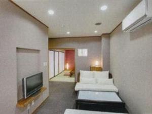 A bed or beds in a room at Kawaguchi Onsen Ousanso