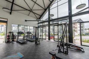 a gym with a bunch of equipment in a building at Just Beachy Bellamare Apartment in Summerstrand