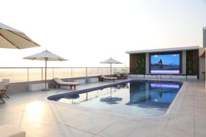 a large swimming pool with a television in a building at Wescott Plaza Hotel Apartments LLC Formerly West Zone Plaza Hotel Apts in Dubai