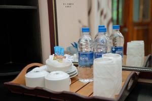 a tray with bottles of water and toilet paper on a table at Tea Forest Lodge in Ella