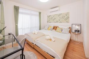 Postel nebo postele na pokoji v ubytování Jone叙園商店街近隣駅徒步5分 新宿12分