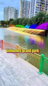 a park with a fence next to a body of water at Khu đô thị Vinhomes Grand Park Tp Thủ đức Tp HCM in Long Bình