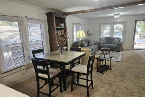 a living room with a table and chairs and a couch at Moody Woods in Orange Park