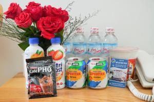 a bunch of bottles of milk and flowers and a telephone at Biển Nhớ Hotel & Coffee in Phan Thiet