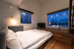 Postel nebo postele na pokoji v ubytování Momo Niseko