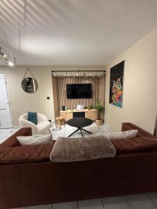 a living room with a large couch and a chair at L Extension du Bonheur à Meisenthal in Meisenthal