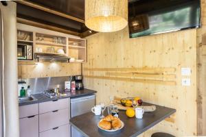 a kitchen with a table with bread and fruit on it at CityKamp Valkenburg - Maastricht in Valkenburg