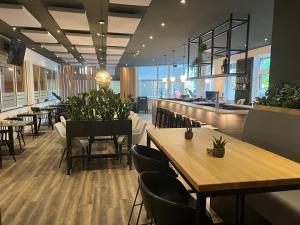 a restaurant with tables and chairs and a bar at Erlebniswelt Resort Apartment 5 in Reken