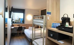 a room with bunk beds and a desk with a computer at Campanile Toulouse Balma - Cité de l'Espace in Toulouse +69 photos