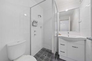a white bathroom with a toilet and a sink at Comfort Inn Serenity Bathurst in Bathurst +115 photos