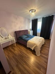 a bedroom with a bed and a mirror on the floor at Prime Browary Apartment in Warsaw