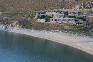 a building on a hill next to a beach at Coco-Mat Eco Residences Serifos in Vayia